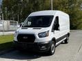 White 2022 Ford Transit van with a black front grille parked in a lot showcasing its large cargo space and design