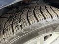 Close-up of a worn tire tread on a wheel of a 2013 Dodge Journey showing patterns and grooves for traction