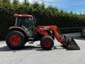 A red and orange 2011 Kubota M8540D tractor with a front loader attachment facing to the left