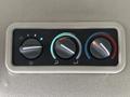 Three round dials for climate control in a vehicle with indicators for fan speed and temperature settings