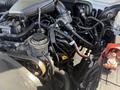 2015 Toyota Tacoma engine with various hoses and components visible, including the air intake and oil cap