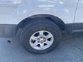 Close-up of a silver 2013 Ford Expedition tire and wheel showcasing a shiny rim and all-terrain tread pattern