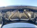 The underside of the trunk lid of a 2019 Dodge Charger showing the structural elements and the mechanism for the trunk latch