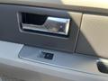 Close-up of the door handle and window controls of a 2013 Ford Expedition