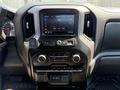 Interior dashboard of a 2021 Chevrolet Silverado 1500 featuring a touchscreen display controls and air conditioning knobs