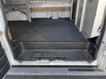 A 2016 GMC Savana cargo van with an open rear door revealing a black rubber floor and a step for easy access into the back space