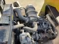 Close-up of the engine compartment of a 2010 Kubota F3990 showing various mechanical components including hoses and the air filter assembly