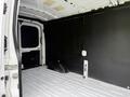 Interior of a 2022 Ford Transit van showing a spacious cargo area with a smooth floor and black side panels