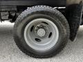 Close-up of a wheel from a 2018 Ford Econoline featuring a gray rim and a rugged tire with the brand name Ares shown clearly on the sidewall
