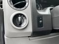 Close-up of the control panel in a 2013 Ford Econoline featuring knobs for air circulation and light settings