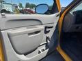 A 2013 Chevrolet Silverado 1500 with a gray interior door panel featuring a door handle a window crank and a pocket for storage