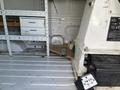 Interior view of a 2008 Ford Econoline with metal and wood shelving units and control panel visible on the side
