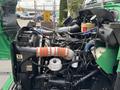 A 2013 Kenworth T370 truck engine with various hoses and components including an air intake and coolant reservoir in view