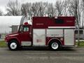 A red 1995 Freightliner FL70 fire rescue truck with a white stripe and compartments on the side featuring emergency lights on the roof