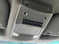 Interior overhead console of a 2017 Ford F-550 featuring control buttons labeled AUX and speaker grills