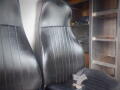 Two black vinyl seats with vertical seams in a cab interior of a 2008 Freightliner MT45 Chassis