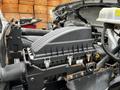 Close-up of the engine compartment of a 2013 Ford F-650 showing the air intake and various components including hoses and tubes