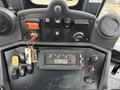 Control panel of a 2011 John Deere 310SJ 4x4 Wheel Loader featuring various switches buttons and a display showing volts and other settings