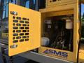 Close-up of the engine compartment of a 2022 TerraMac Tracked Dump showing the yellow access door and visible machinery components inside