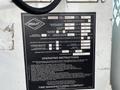 A 2008 Ford Econoline with a technical instruction placard affixed to it detailing operating instructions and specifications