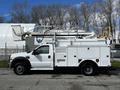 A 2008 Ford F-550 truck with a utility body and a mounted aerial lift bucket on top for maintenance or service work
