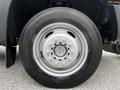 Wheel of a 2011 Ford F-550 featuring a silver rim with multiple lug nut openings and a black tire with visible tread pattern
