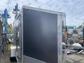 A black and silver 2020 Stealth Enterprises trailer with a diamond plate base and a metal door on the side