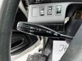 A close-up view of the turn signal lever and control switches on the steering column of a 2020 Hino 338