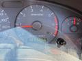 Dashboard of a 2003 Ford Mustang showing the speedometer rpm gauge and digital odometer reading 1237255