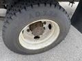 A close-up view of a tire mounted on a wheel of a 2014 International Durastar truck showing the tread pattern and a visible wheel hub