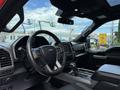 Interior view of a 2019 Ford F-150 showcasing the steering wheel dashboard and center console with gear shift