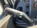 Close-up of a 2004 Freightliner M2 control lever featuring functions for headlights and turn signals with labels for off, push, pull, and flash settings