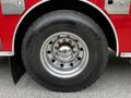 A large tire of a 1991 Sutphen Deluge fire truck with a shiny chrome rim and a Michelin label visible on the side of the tire