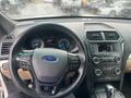 Interior view of a 2016 Ford Explorer showing the steering wheel dashboard and center console with various controls and displays