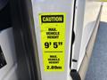 A caution sticker on the door of a 2019 Mercedes-Benz Sprinter indicating maximum vehicle height of 9 feet 5 inches and 2.89 meters