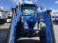 A blue 2010 New Holland T4050 tractor with a front loader attachment visible details include the cab and front wheels