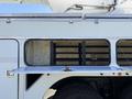 A 2008 International 7500 truck with an open storage compartment showing shelves inside and a large wheel partially visible below