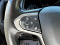 Close-up of the steering wheel controls in a 2021 Chevrolet Colorado featuring buttons for cruise control and various functions