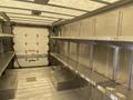 Interior of a 2012 Ford Econoline with metal shelves and loading area visible