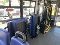 Interior view of a 2020 Chevrolet Express featuring two blue seats and equipment including a wheelchair lift on the right side