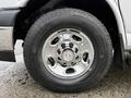 Close-up of a shiny chrome wheel rim with a Chevrolet logo and a Michelin tire on a 2021 Chevrolet Express