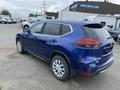A blue 2019 Nissan Rogue parked with its rear angled slightly to the side showcasing its sleek design and modern features