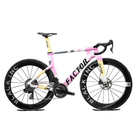 A 2026 Factor One SRAM Force bike featuring a power meter, carbon frame, aerodynamic design, and striking pink and yellow color scheme with BLACK INC wheels