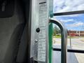 Close-up of a 2013 Kenworth T370 interior door frame featuring a PACCAR information label and a chrome door handle