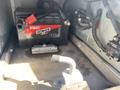 A 2020 Chevrolet Express with a visible black battery labeled Ultimate A2 positioned in the engine compartment.