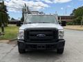 Front view of a 2015 Ford F-350 Super Duty with a chrome grille and orange clearance lights on the roof