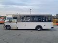 A 2017 Chevrolet Express shuttle bus in white with large windows and a black strip along the top of the body