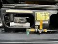 The image shows the control panel of a 2006 GMC C5000 featuring various switches and gauges along with a water pump valve and a labeled yellow note