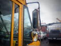 A 2008 Freightliner MT45 Chassis showing the side mirror and part of the window frame in close up view