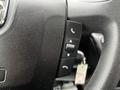 Close-up of the steering wheel controls in a 2018 RAM Promaster featuring buttons for phone and cruise control functions